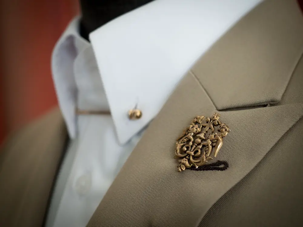 Lapel pin on beige jacket with white shirt