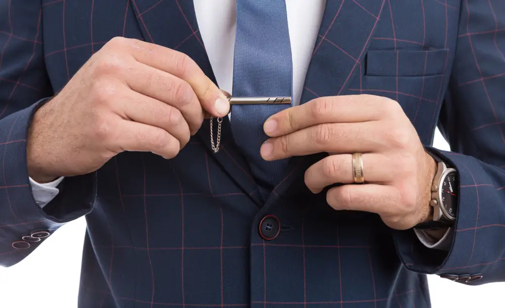 Man adjusting tie pin as fashion with luxury expensive suit