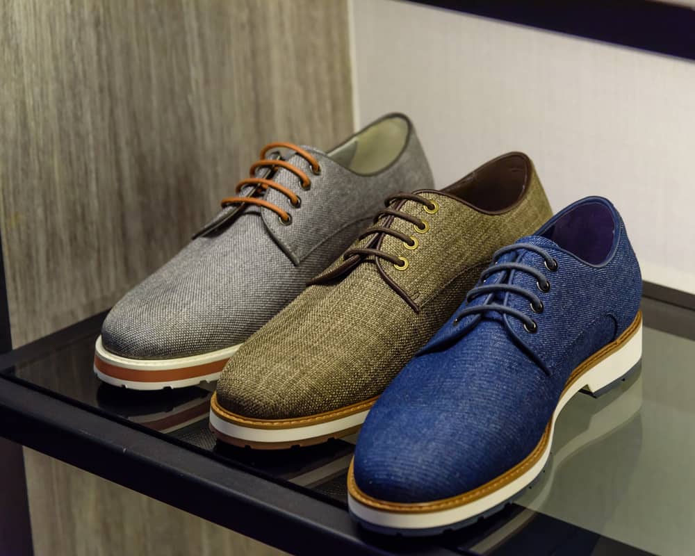 Variety colorful leather casual derby shoes on the shelf in fashion footwear