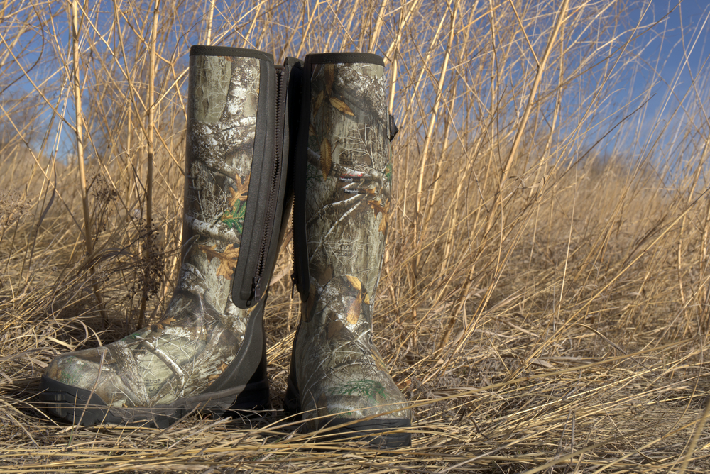 Waterproof hunting boots for hiking, wading and fishing. Earth toned backgrounds show the camouflage