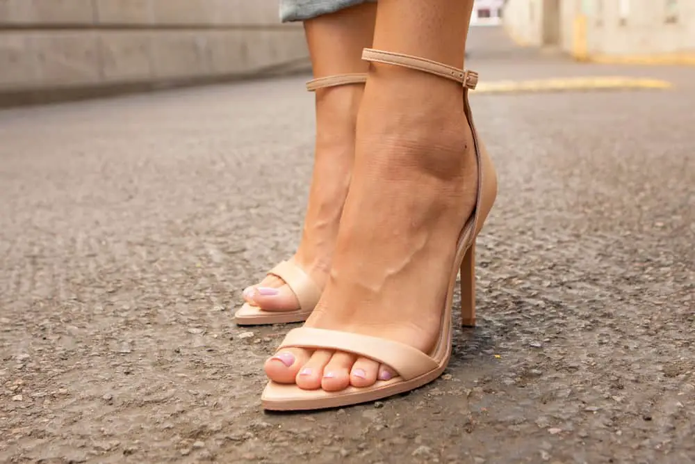 Woman's open toe nude leather heels with a perfect pedicure