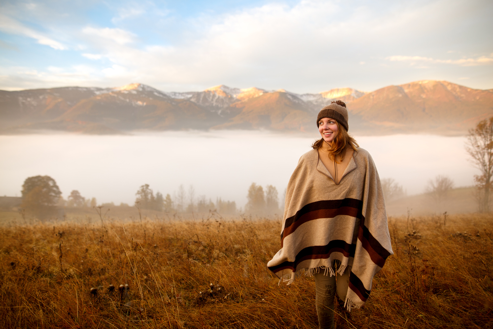 girl wrapping in warm poncho outdoor