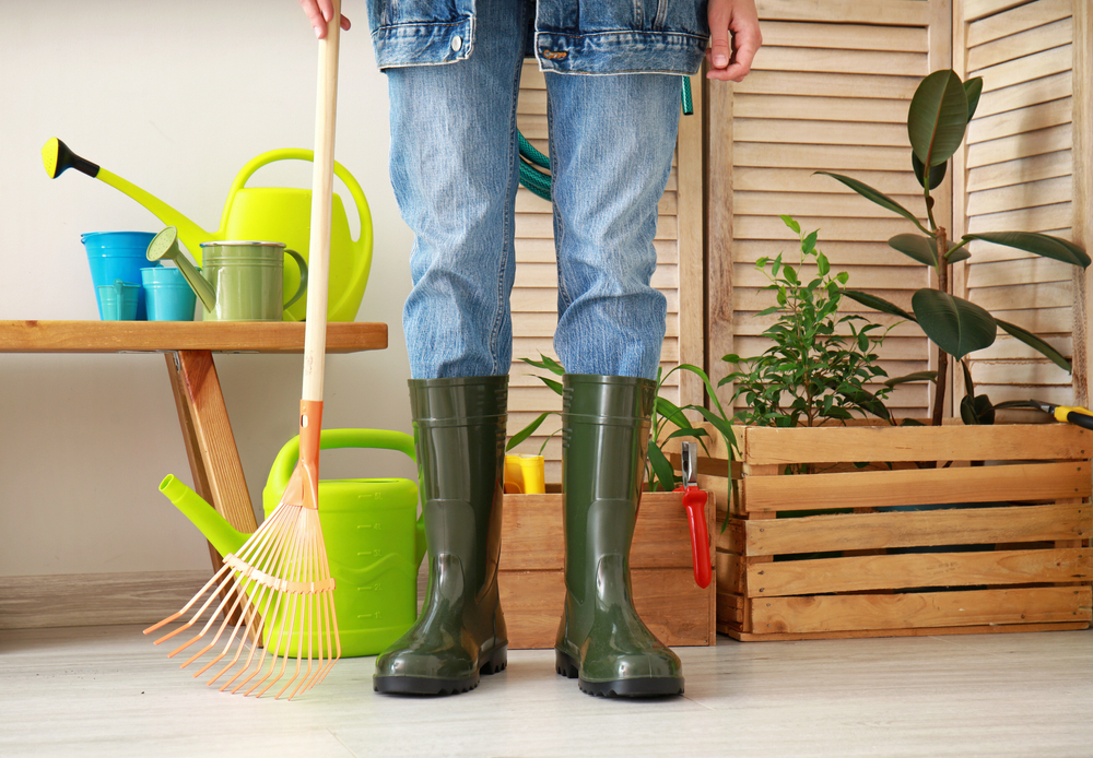 gumboots with gardening supplies in barn