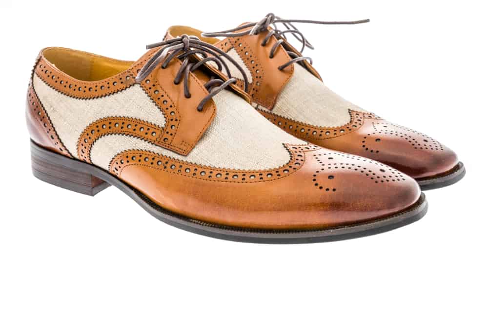 pair of beige and mesh wingtip dress shoes