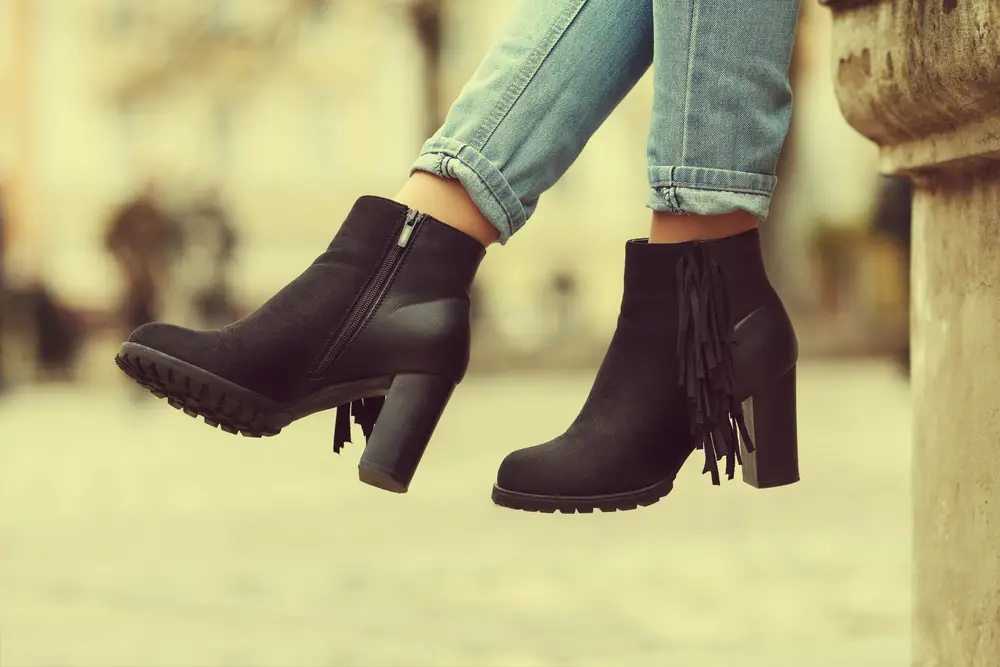 stylish black suede ankle boots. Fashionable girl