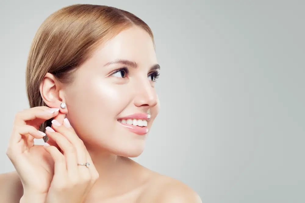woman with diamond earrings and ring