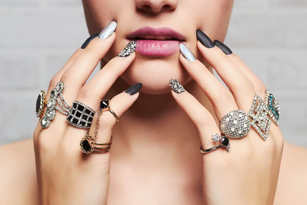 woman's hands with fashion jewelry rings