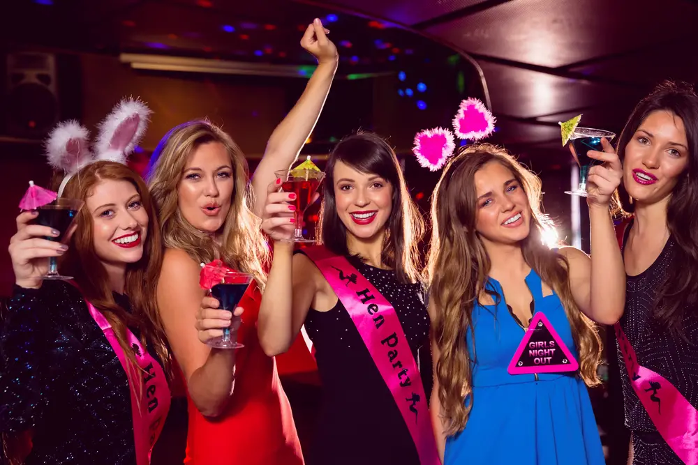 women wearing sashes at nightclub